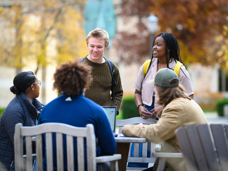 Group of undergrads having a discussion outdoors